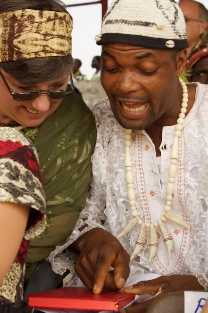 Teaching Mama Karissa how to read the New Testament in Kenyang